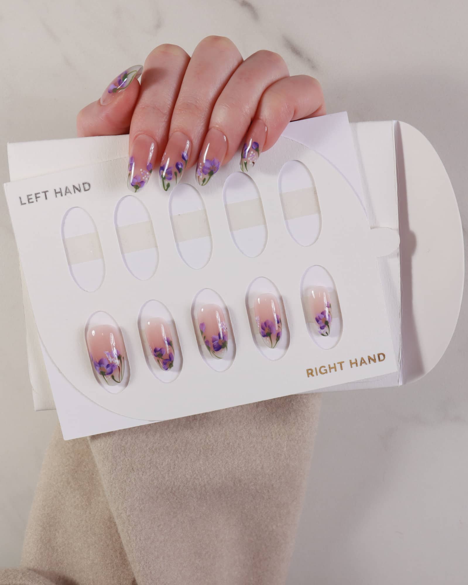 purple flowers nail extensions on hand with box